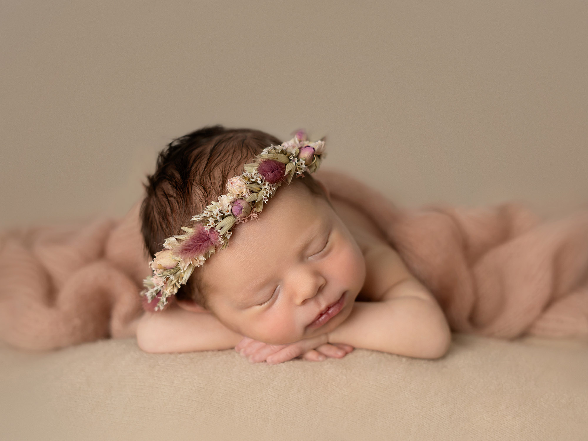 newborn head on hands pose by newborn photographer in Guildford, Surrey