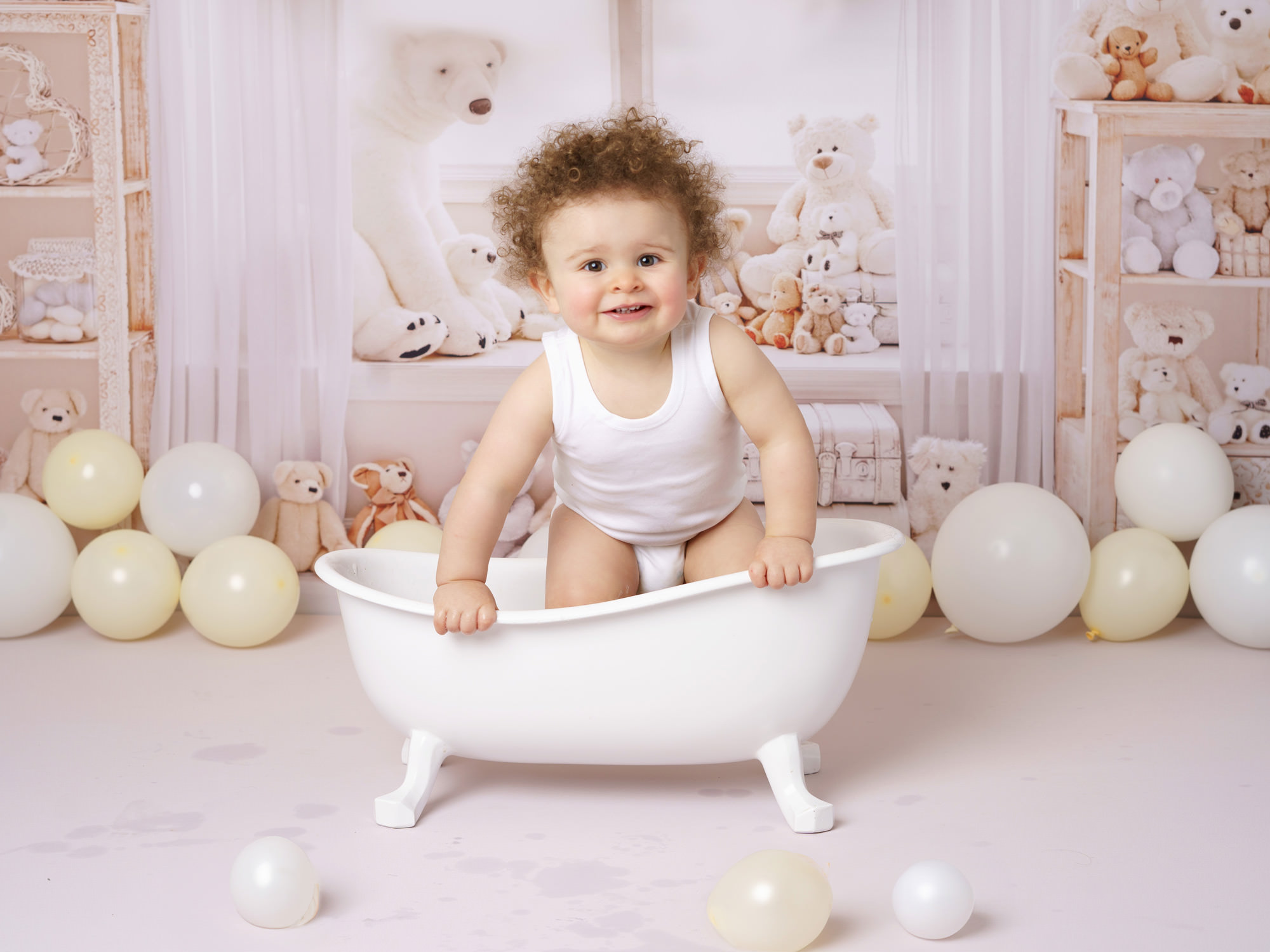 baby boy with curly hair in a bathtub by CAKE SMASH PHOTOGRAPHER SURREY