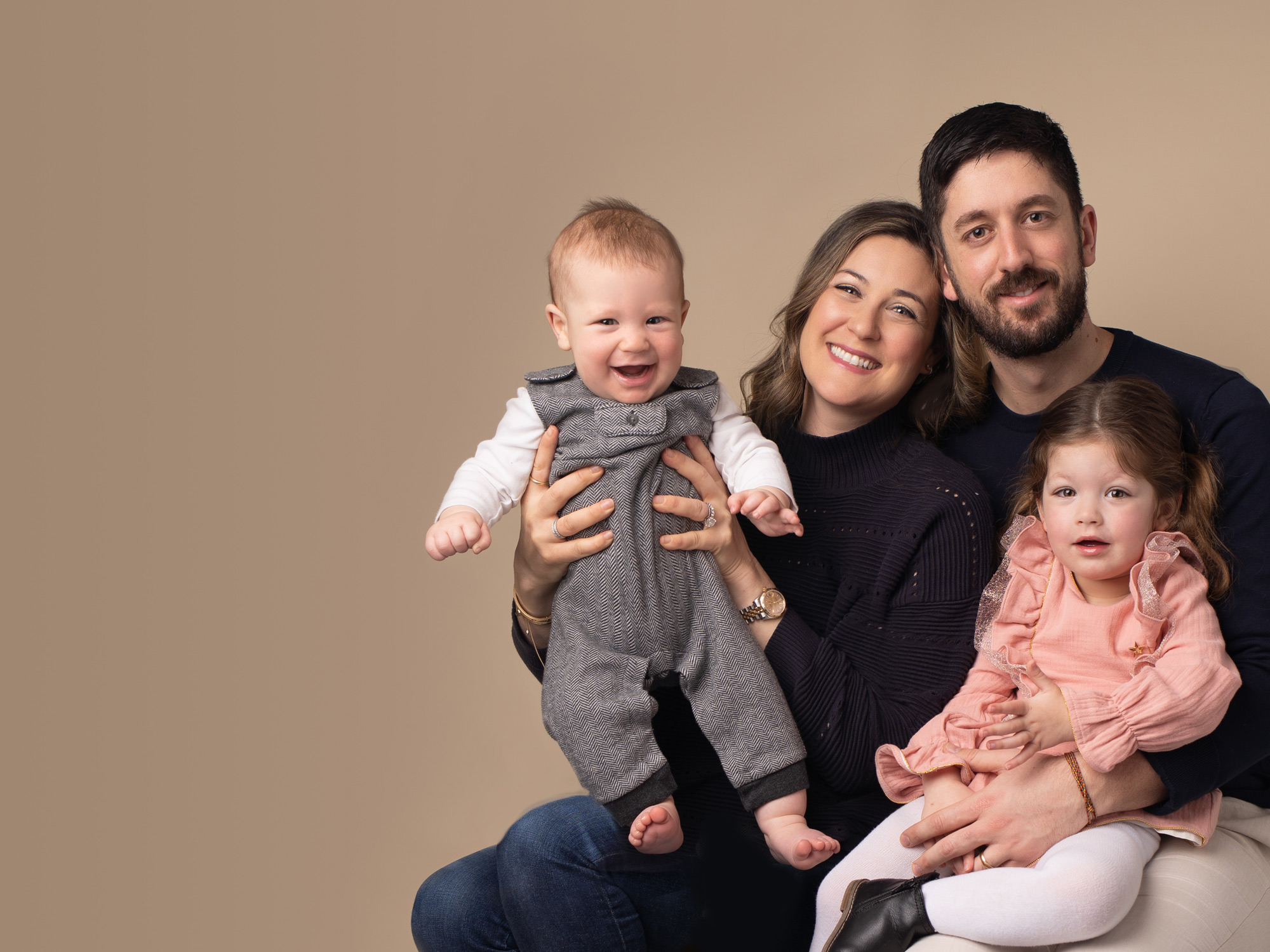 family photographed with children by BABY & FAMILY PHOTOGRAPHER IN SURREY