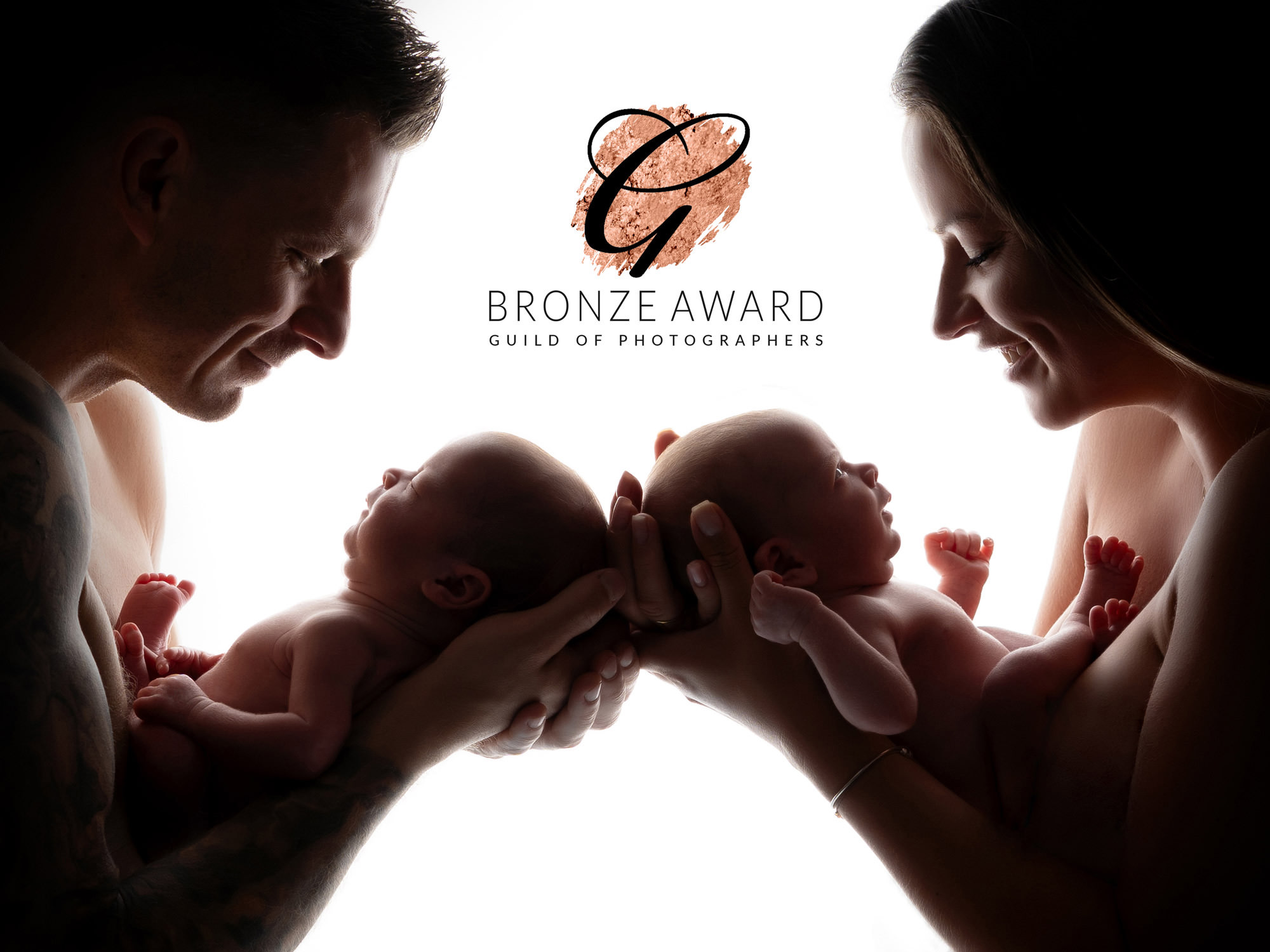 twin newborn babies photographed with parents by newborn photographer in Guildford, Surrey